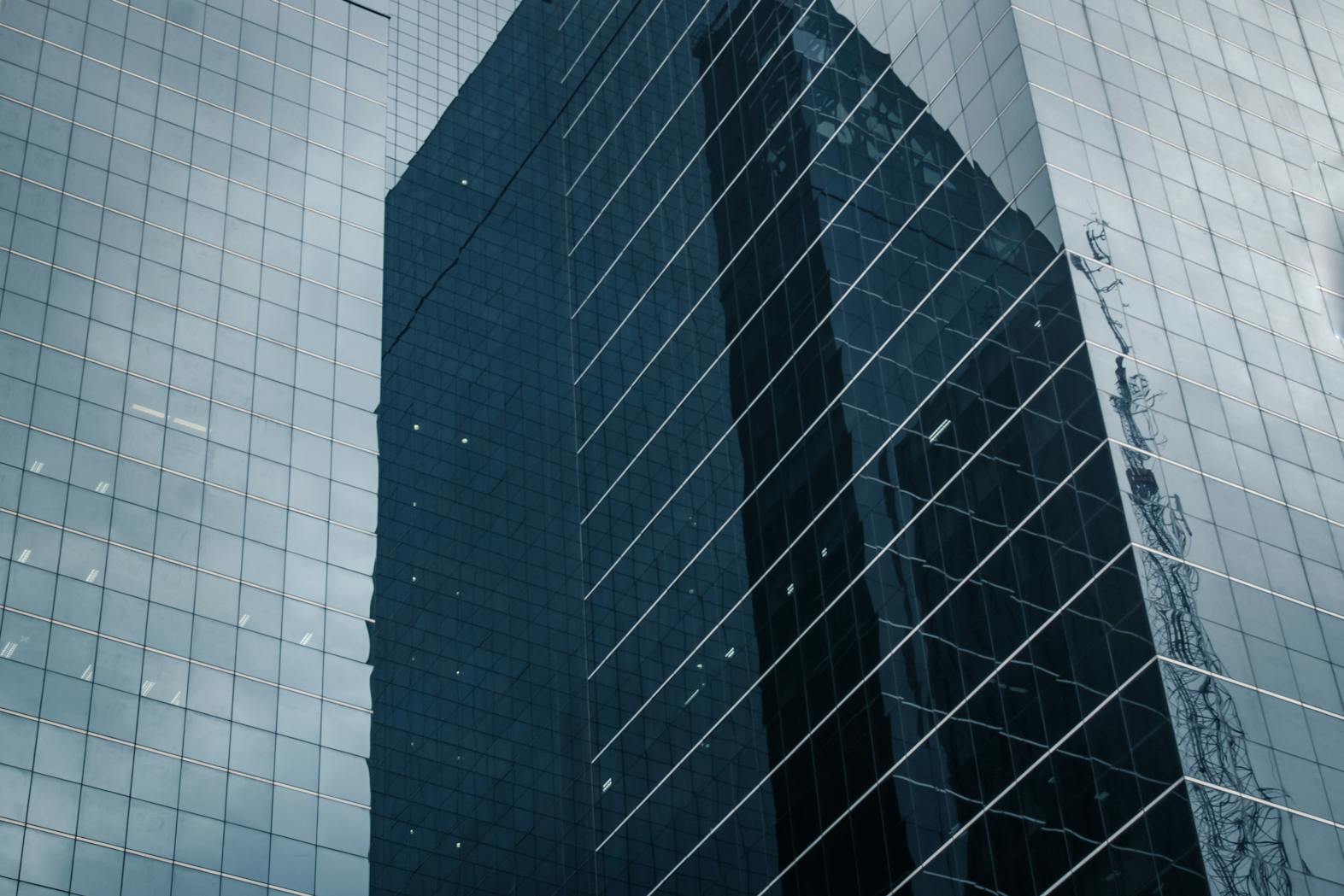 Detailed view of a modern glass skyscraper exterior in São Paulo with reflections.